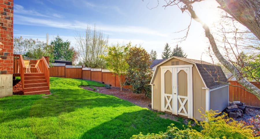 Fenced backyard with storage shed in Dothan